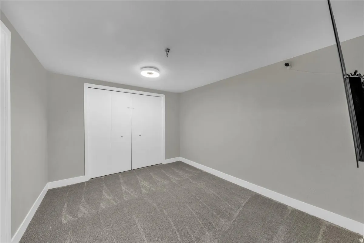 Unfurnished bedroom with a closet and carpet floors