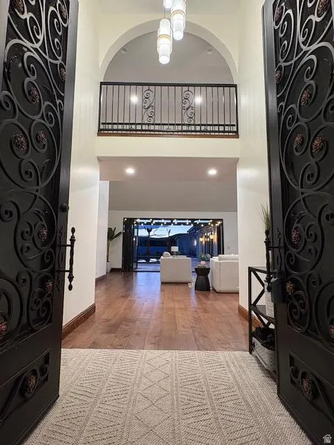 Entryway with a high ceiling and wood finished floors
