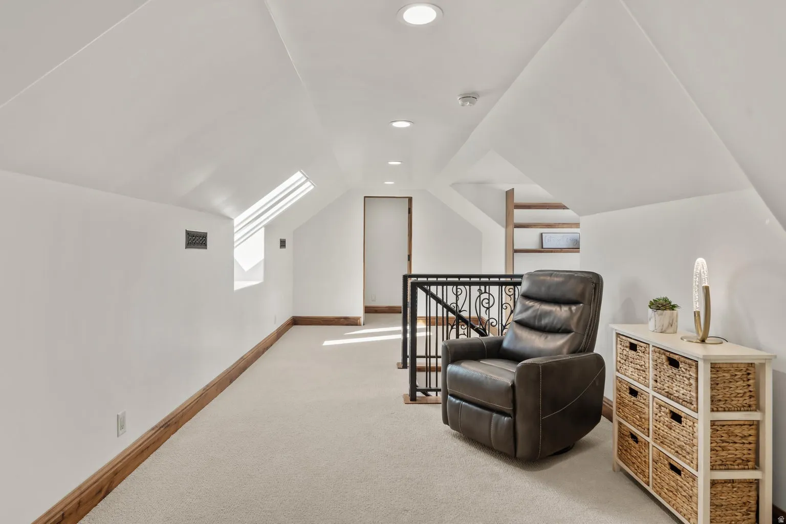 Loft area featuring lofted ceiling, recessed lighting, light carpet, and an upstairs landing