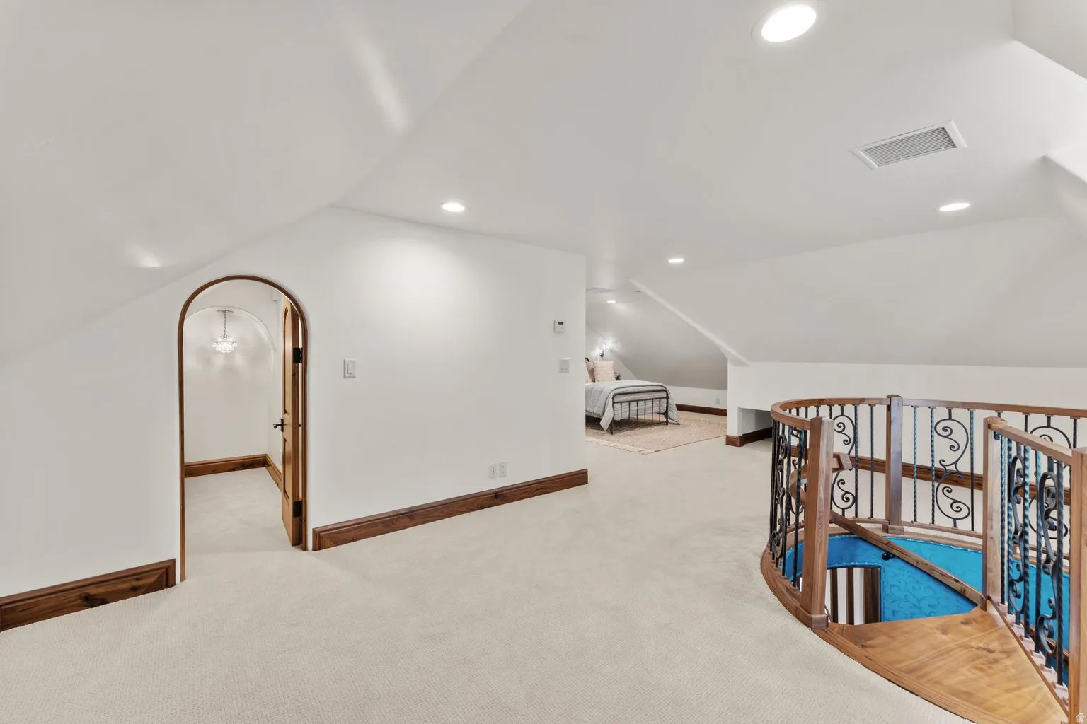 Additional living space on 2nd Level Loft area with light colored carpet and recessed lighting