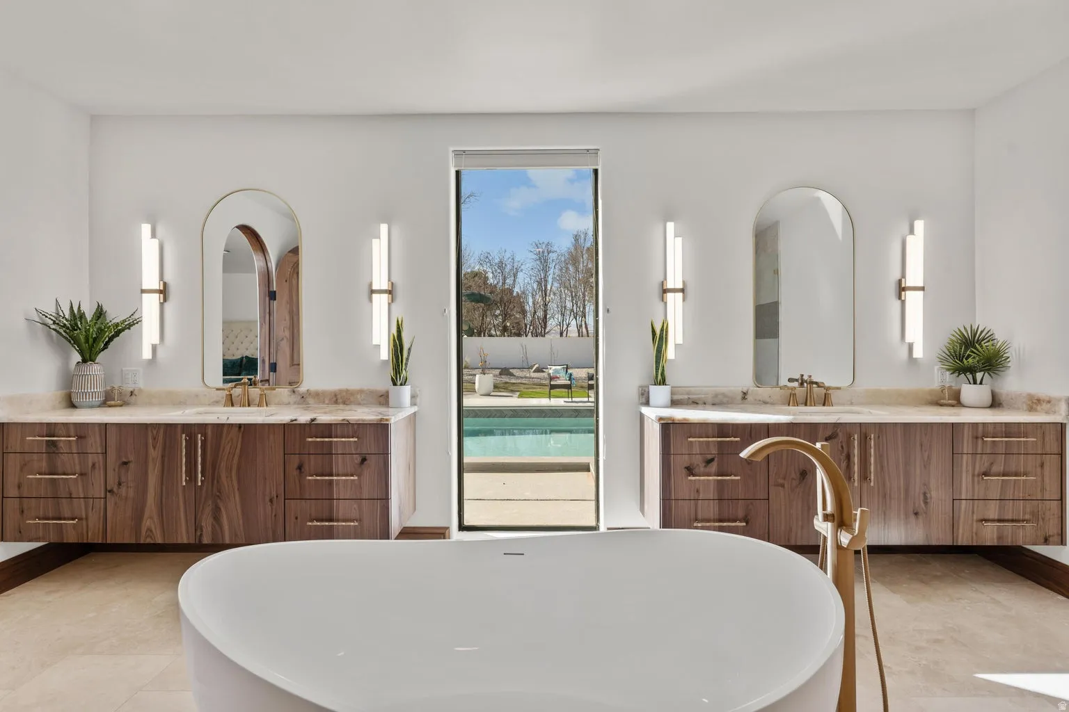 Bathroom featuring a soaking tub and two vanities
