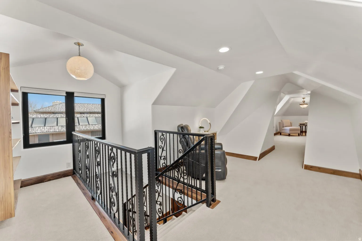 Loft area featuring an upstairs landing, light colored carpet, and recessed lighting