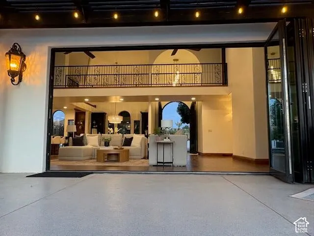 Entrance to property with a patio area and stucco siding
