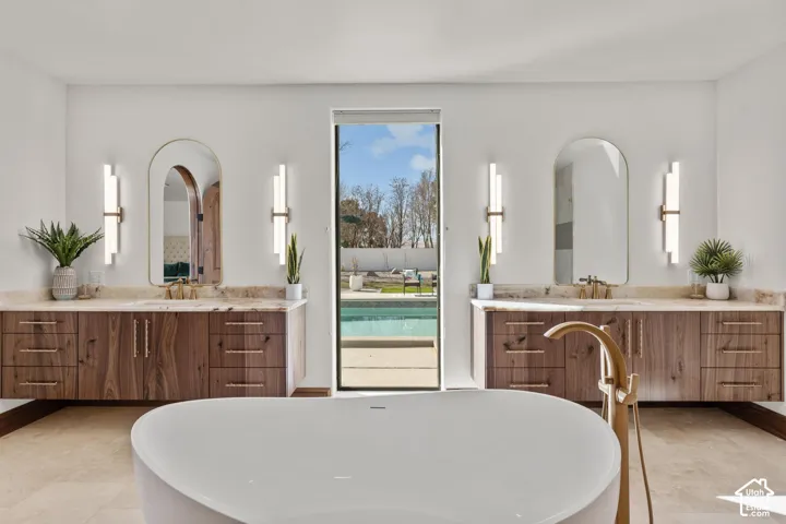 Bathroom featuring a soaking tub and two vanities