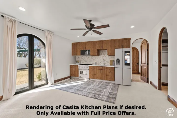 2nd Primary Owner Suite is plumbed for an additional Kitchen with light carpet, arched walkways, white appliances, light countertops, and ceiling fan