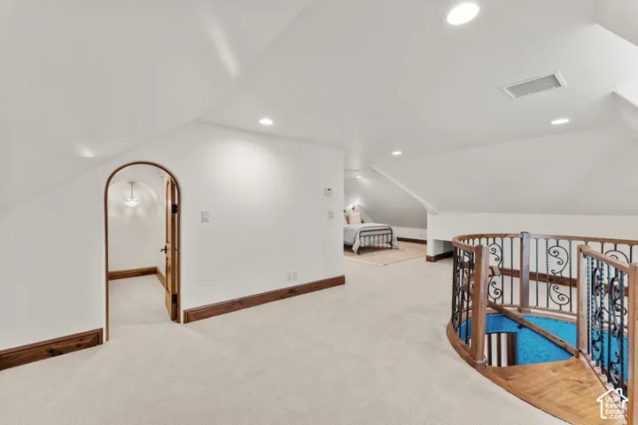 Additional living space on 2nd Level Loft area with light colored carpet and recessed lighting