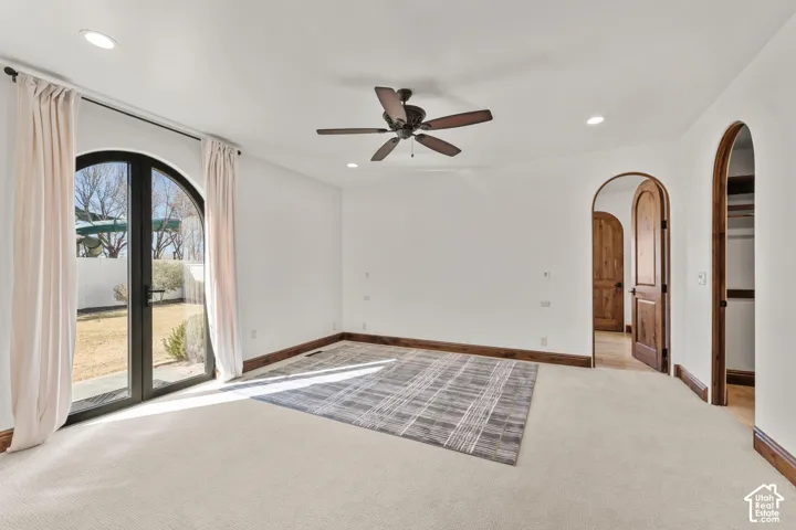 2nd Primary Owner Suite with carpet floors, a ceiling fan, arched walkways, and recessed lighting