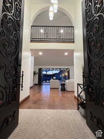 Entryway with a high ceiling and wood finished floors