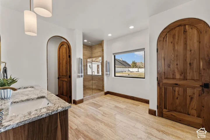 2nd Primary Owner Suite Bathroom with a stall shower, double vanity, recessed lighting, and light wood-style floors