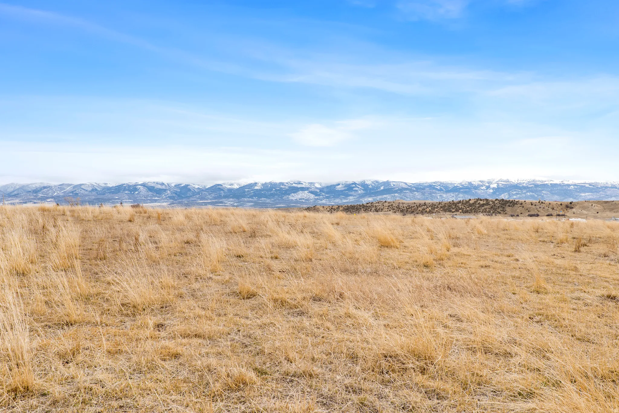 View of mountain backdrop featuring rural landscape