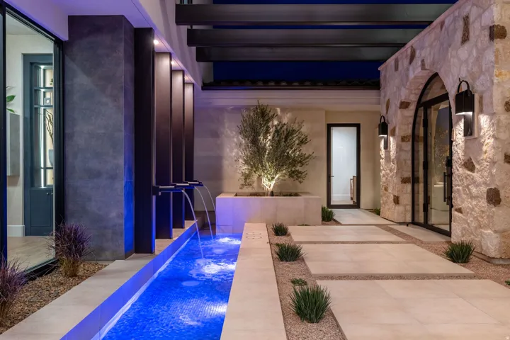 Patio at twilight featuring an outdoor pool