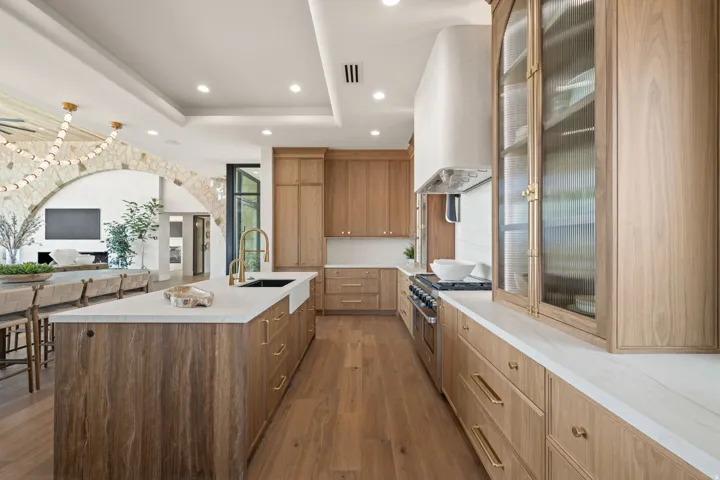 Kitchen with glass insert cabinets, dark wood-type flooring, range with two ovens, recessed lighting, and modern cabinets