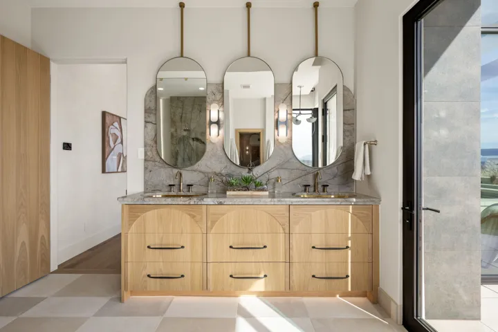 Full bath with double vanity, a shower, and backsplash