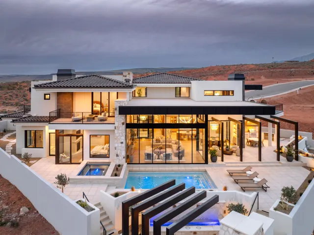 Rear view of property featuring a chimney, a patio area, a mountain view, and a tile roof