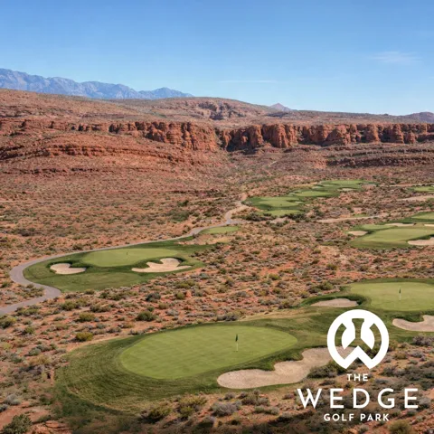 Expansive golf course greens with sand traps, surrounded by natural desert landscaping and distant mountain formations