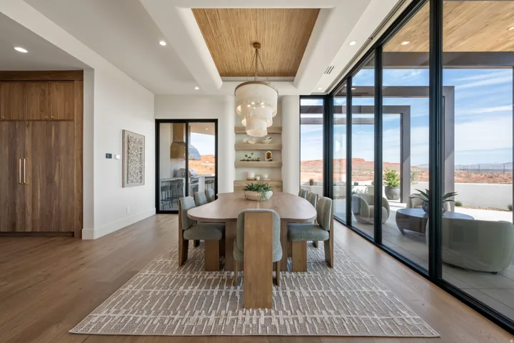 Dining room featuring wood ceiling, dark wood finished floors, a chandelier, and floor to ceiling windows