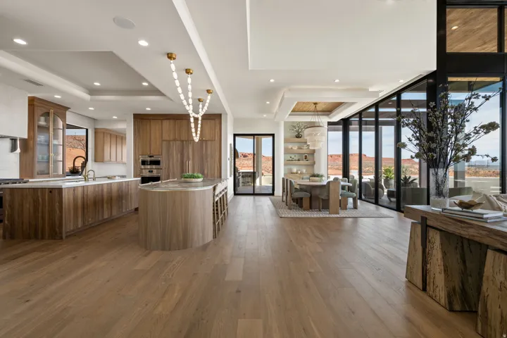 Kitchen with glass insert cabinets, a kitchen island, healthy amount of natural light, dark wood-type flooring, and a raised ceiling