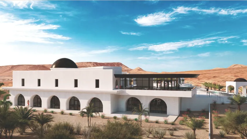 White stucco exterior with a domed roof and arched window openings