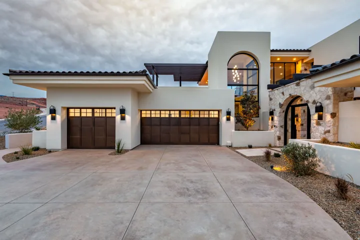 Mediterranean / spanish-style house featuring stucco siding, concrete driveway, and a garage