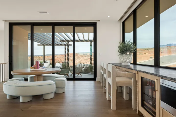 Dining space with a mountain view, beverage cooler, dark wood finished floors, expansive windows, and recessed lighting