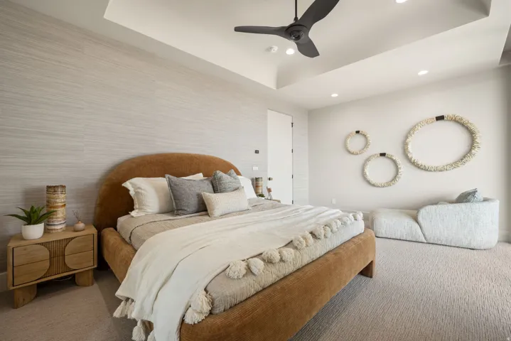 Bedroom featuring a tray ceiling, carpet flooring, ceiling fan, wallpapered walls, and recessed lighting