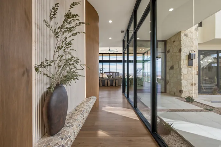 Hallway featuring recessed lighting, wood finished floors, and expansive windows