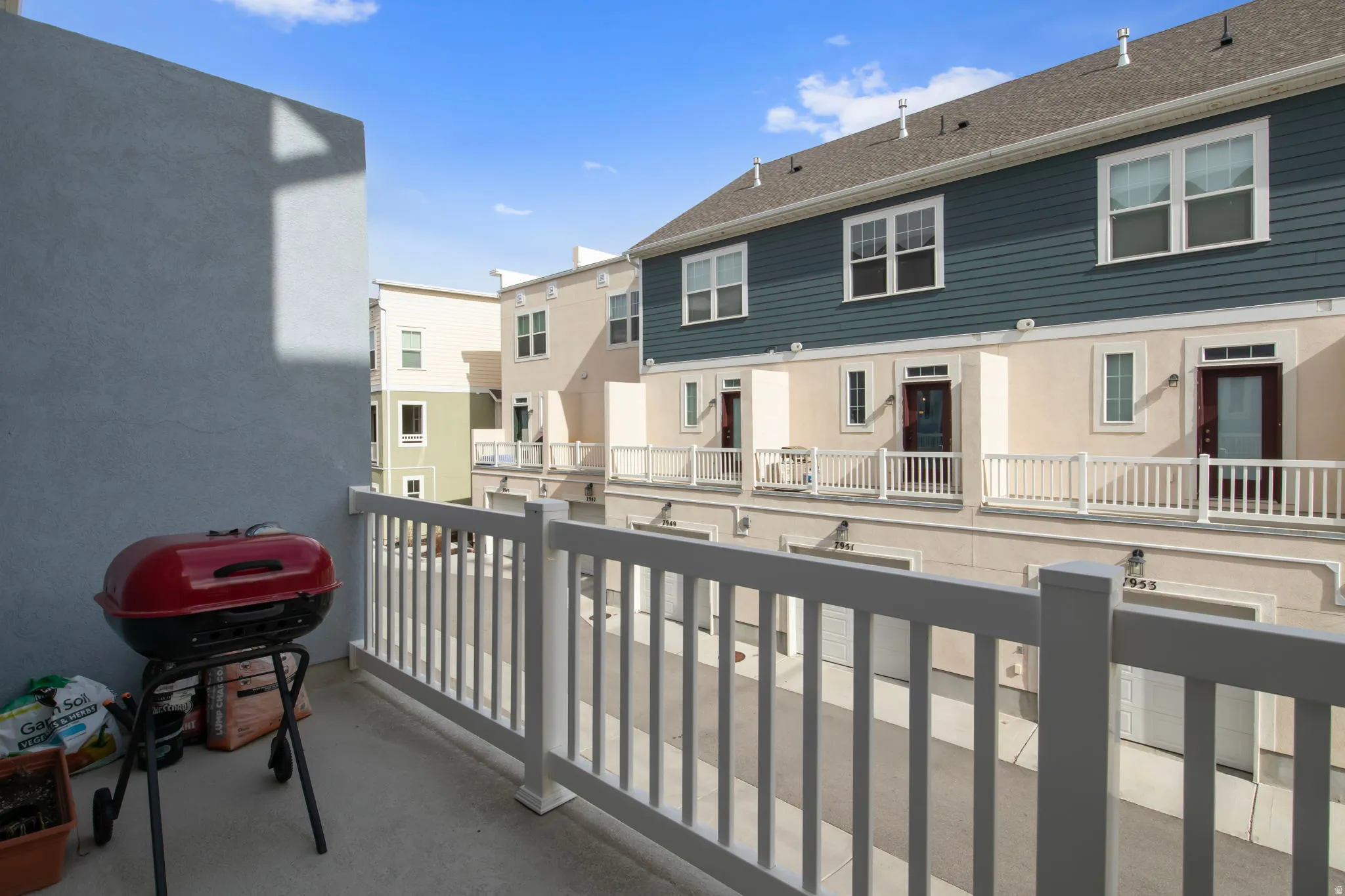Balcony with a grill and a residential view
