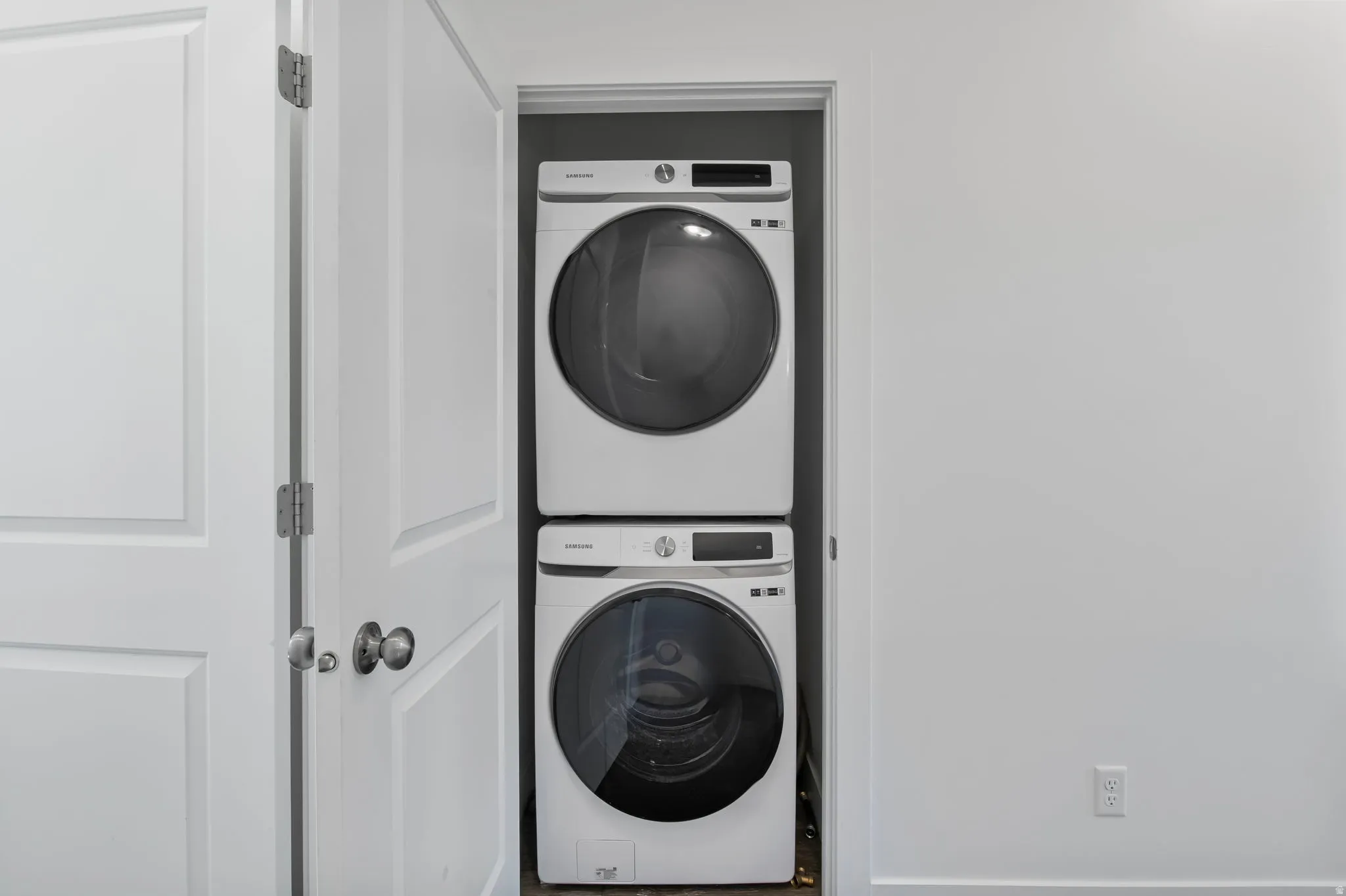 Laundry area with stacked washer / drying machine