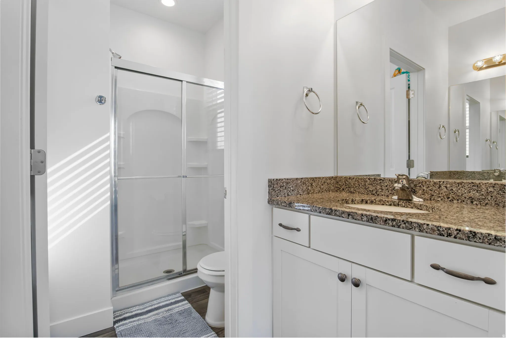 Bathroom featuring a stall shower and vanity