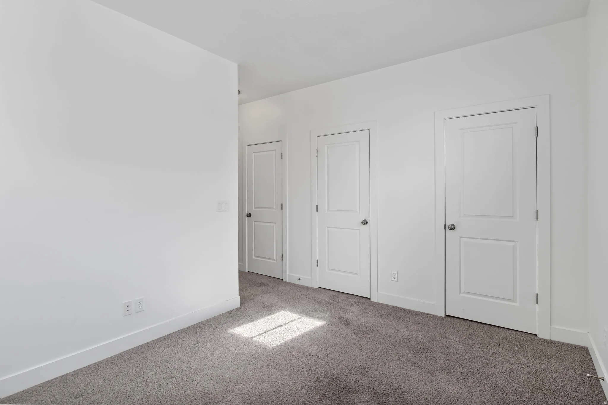 Unfurnished bedroom with baseboards and carpet