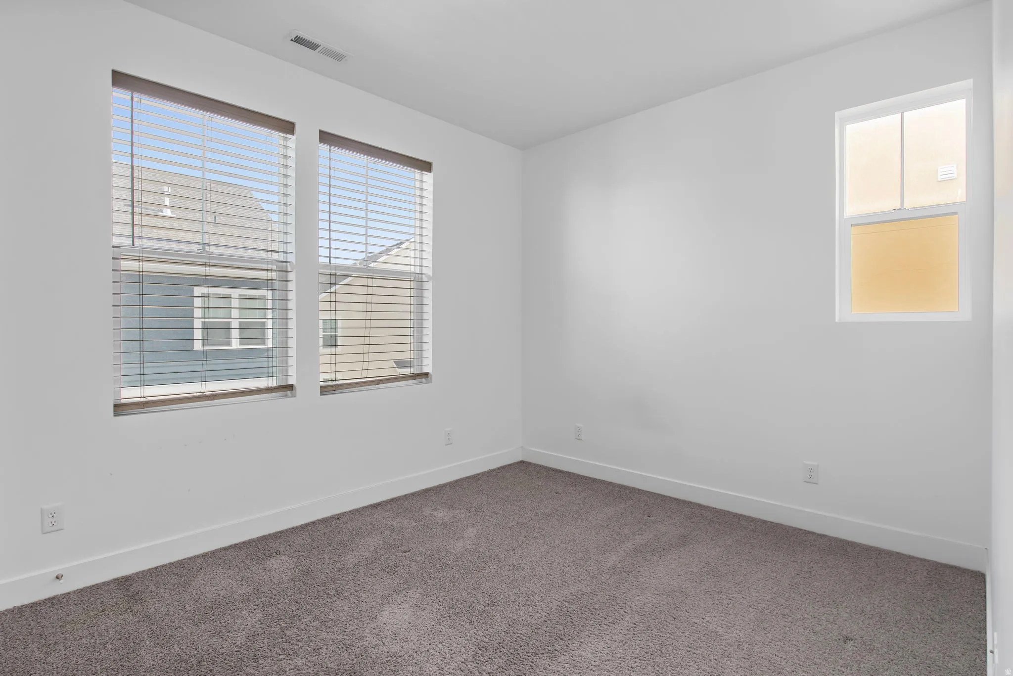 Spare room with carpet and baseboards