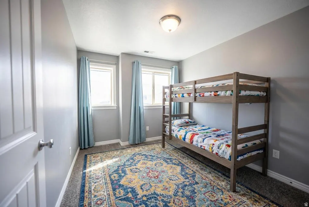 Bedroom featuring baseboards and carpet flooring