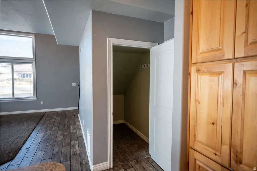Bonus room featuring wood finish floors and baseboards