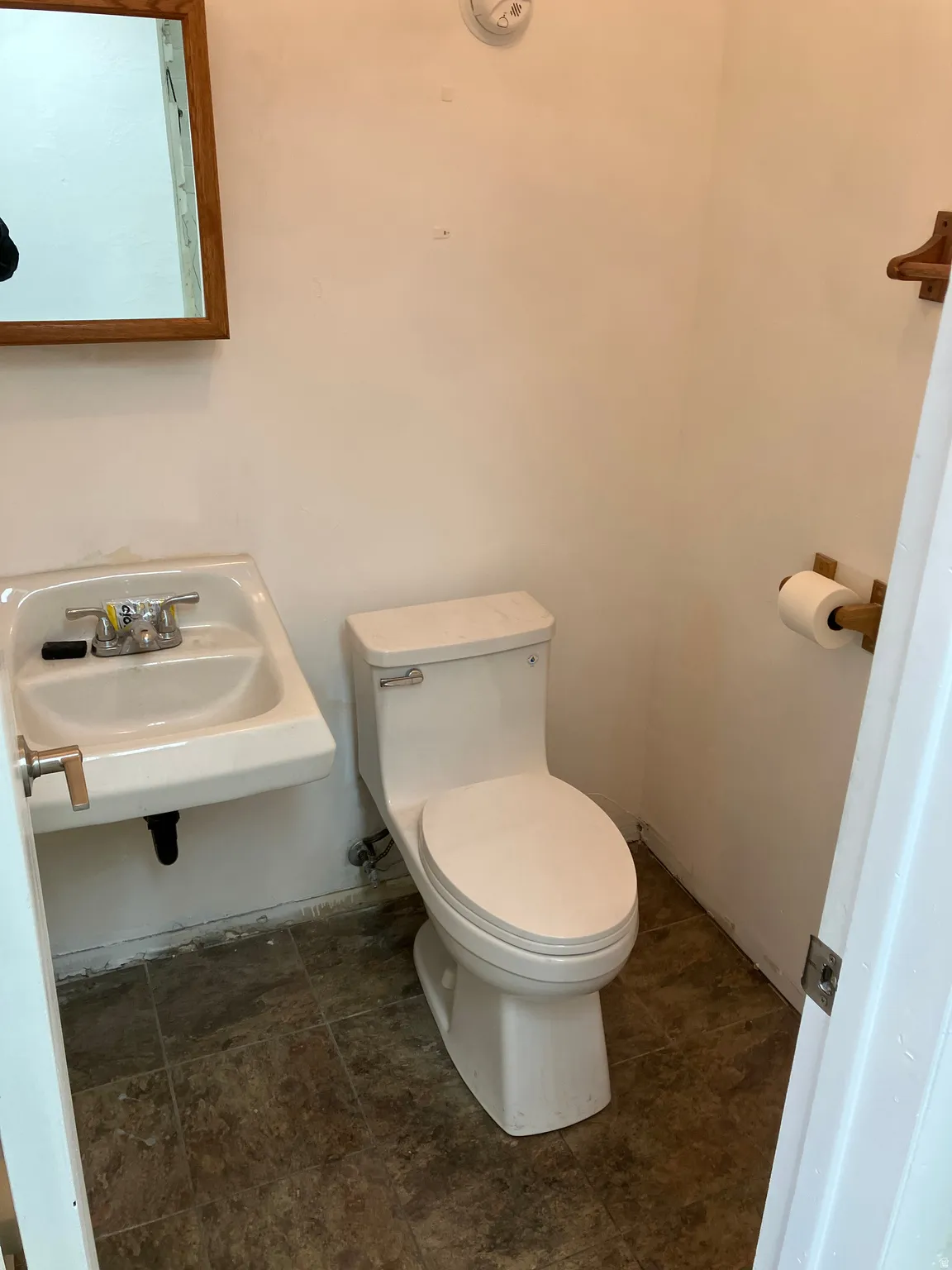 Half bathroom with toilet and a sink