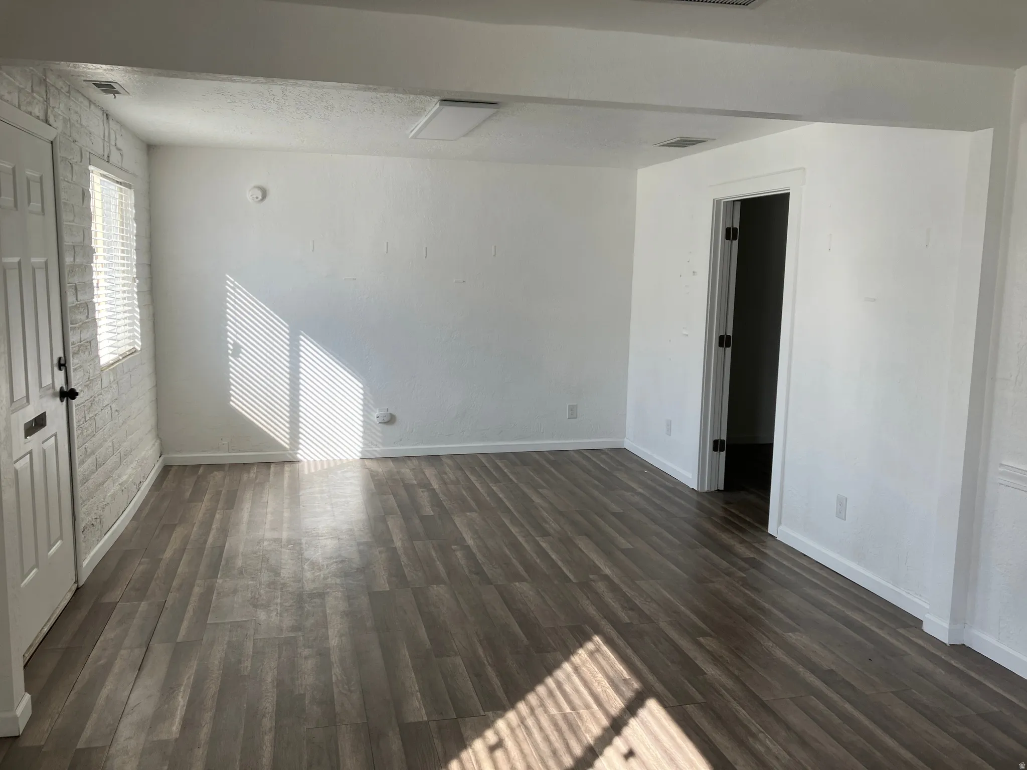 Unfurnished room featuring dark wood-type flooring