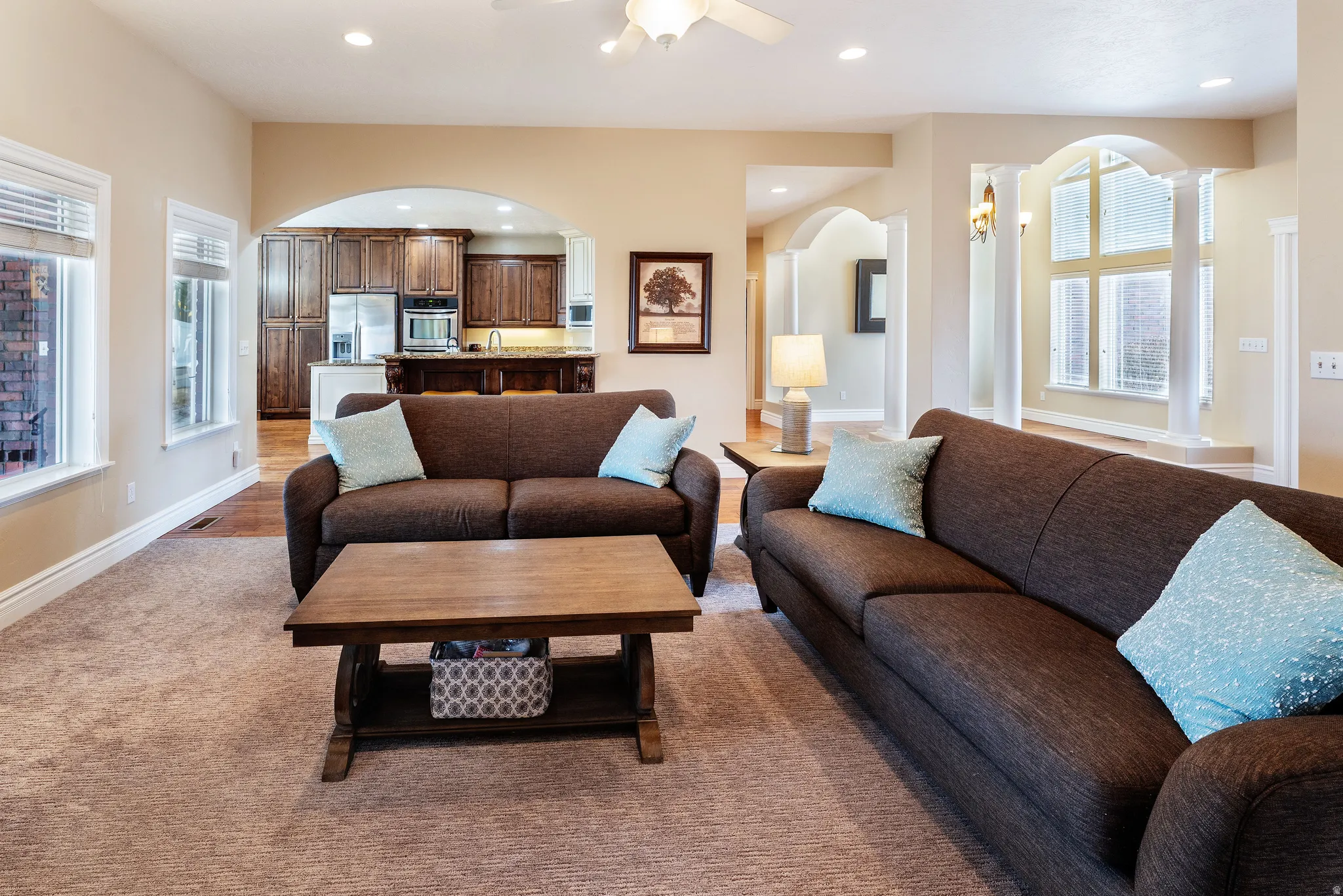 Living area with plenty of natural light, recessed lighting, a ceiling fan, and arched walkways