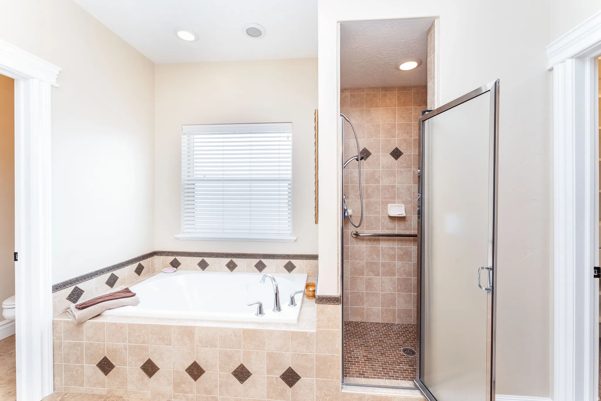 Full bath with a garden tub and a stall shower