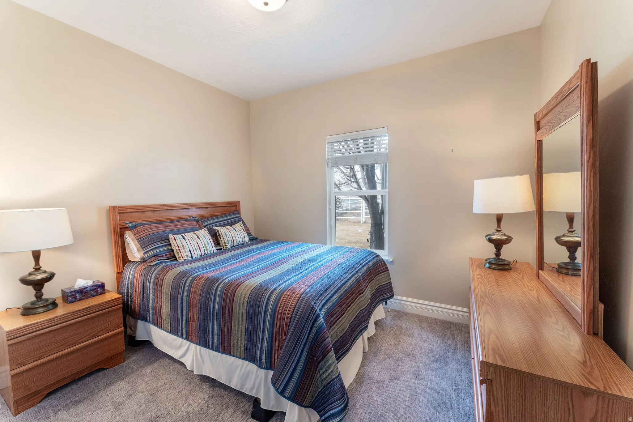 Carpeted bedroom featuring baseboards
