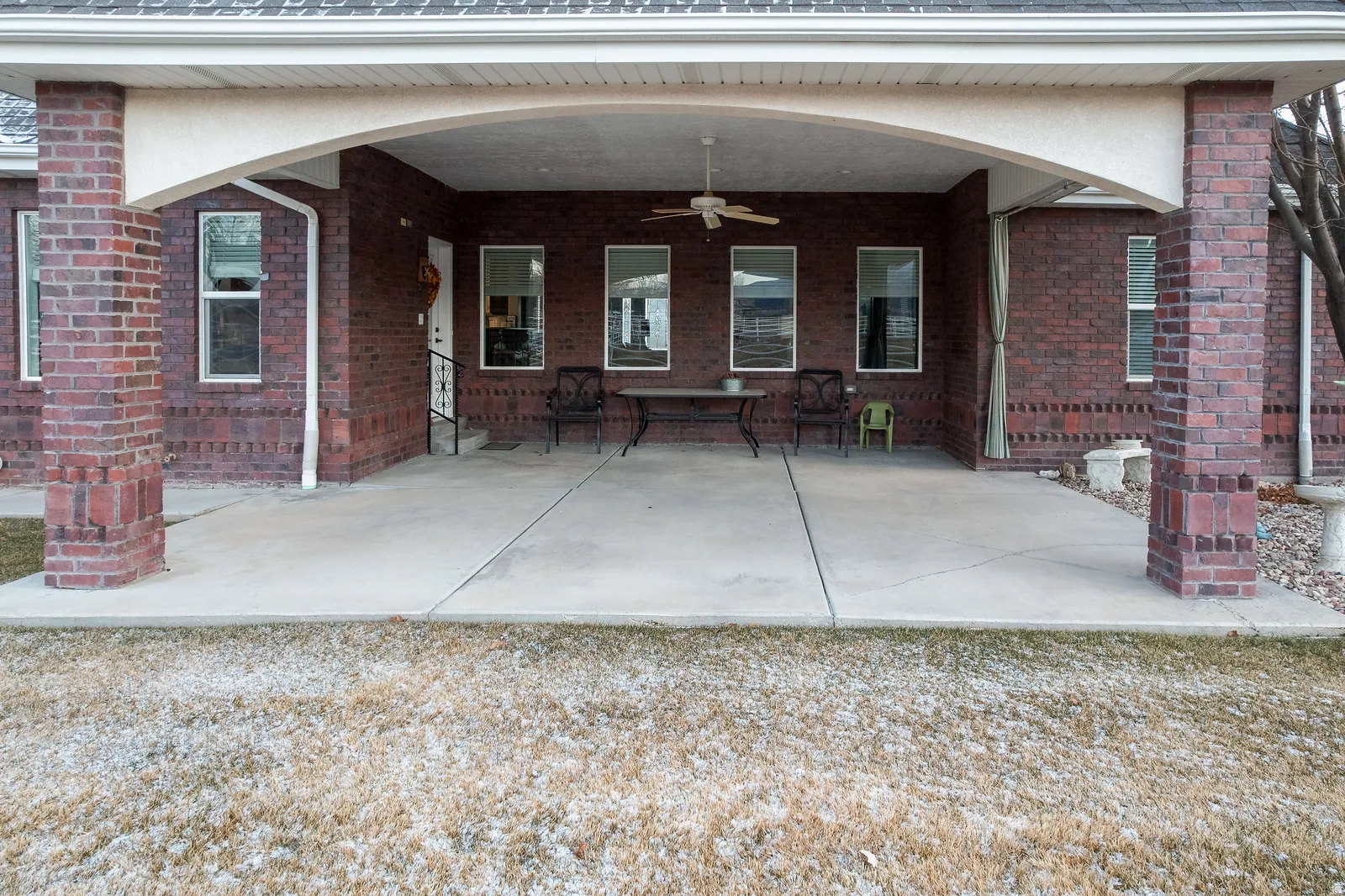 Back of house featuring a patio area, ceiling fan, and brick siding