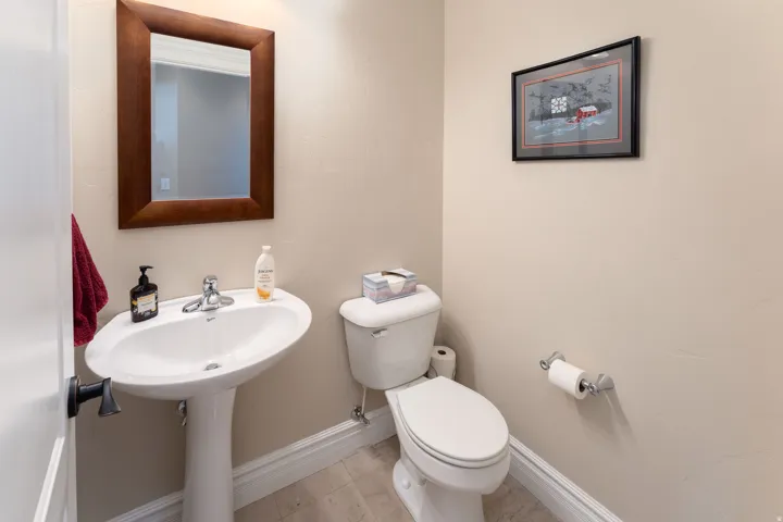 Half bathroom featuring toilet and tile patterned flooring