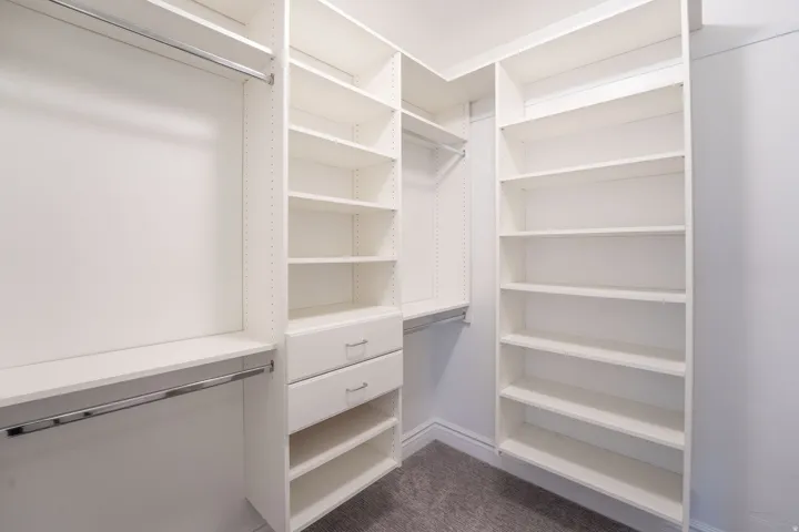 Walk in closet featuring dark carpet