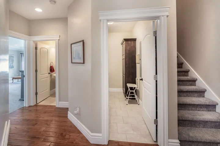 Hallway featuring stairs and light wood-style flooring
