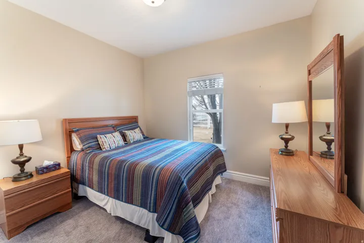 Carpeted bedroom featuring baseboards