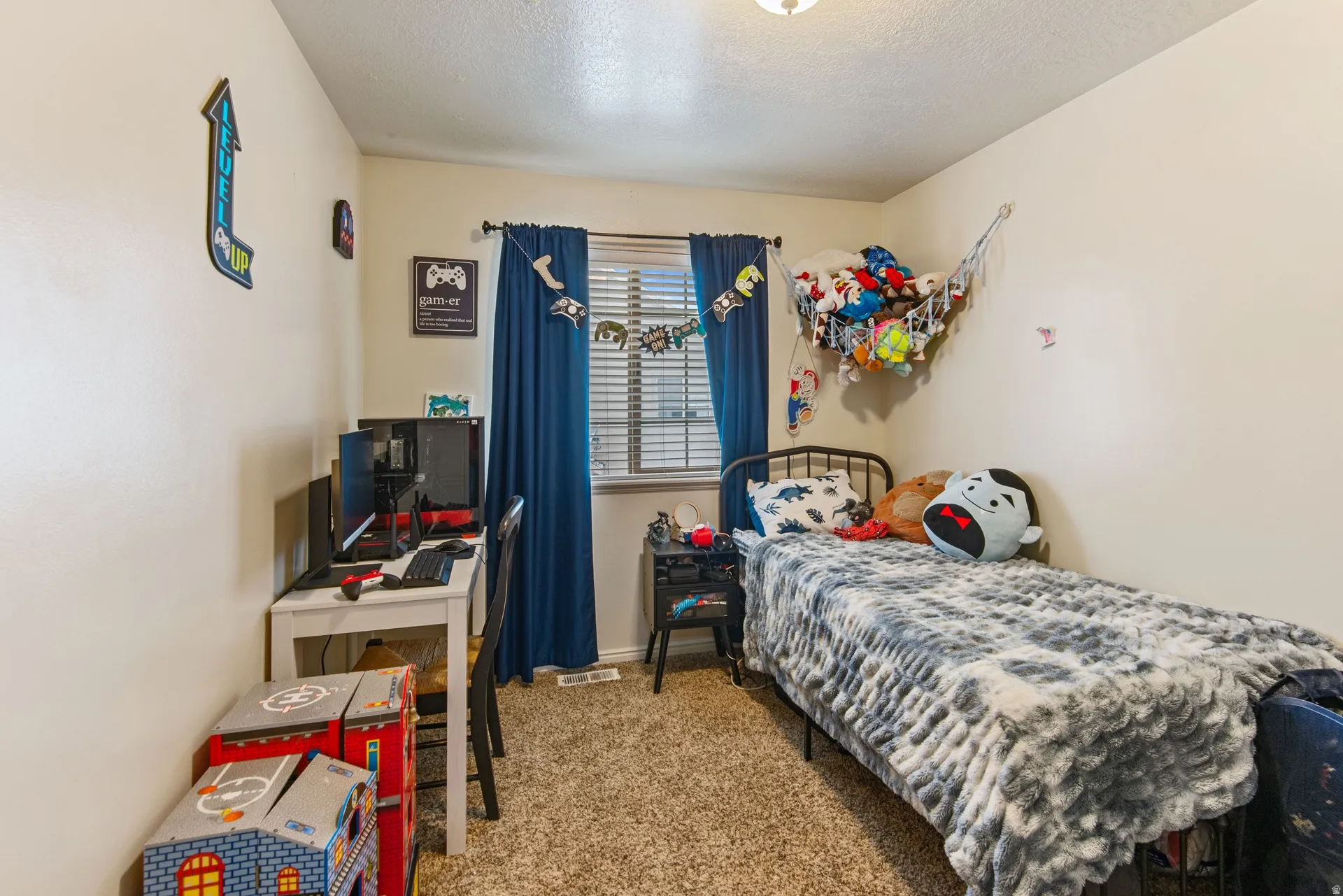 Carpeted bedroom featuring a textured ceiling