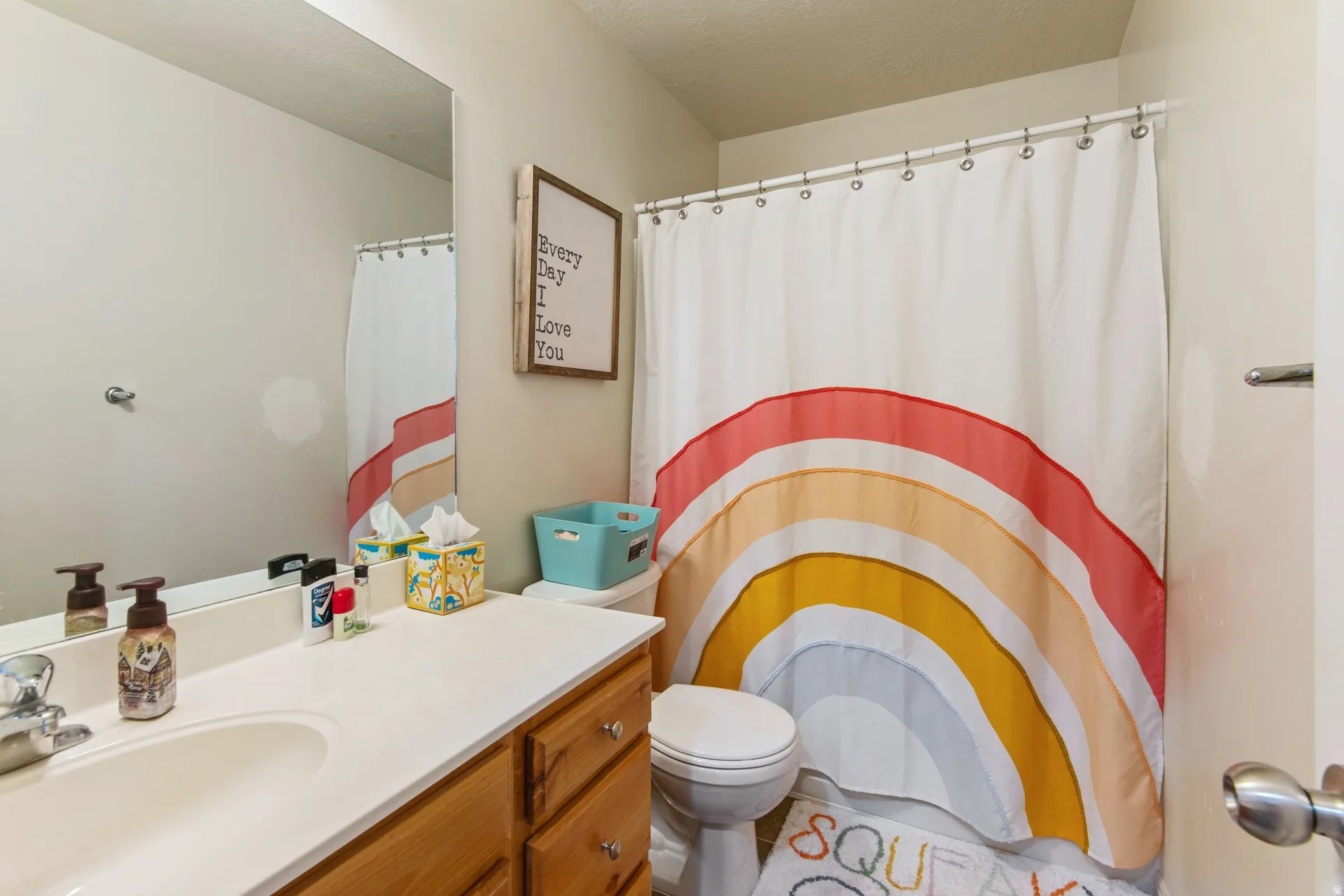 Full bathroom featuring vanity, a shower with shower curtain, and a textured ceiling