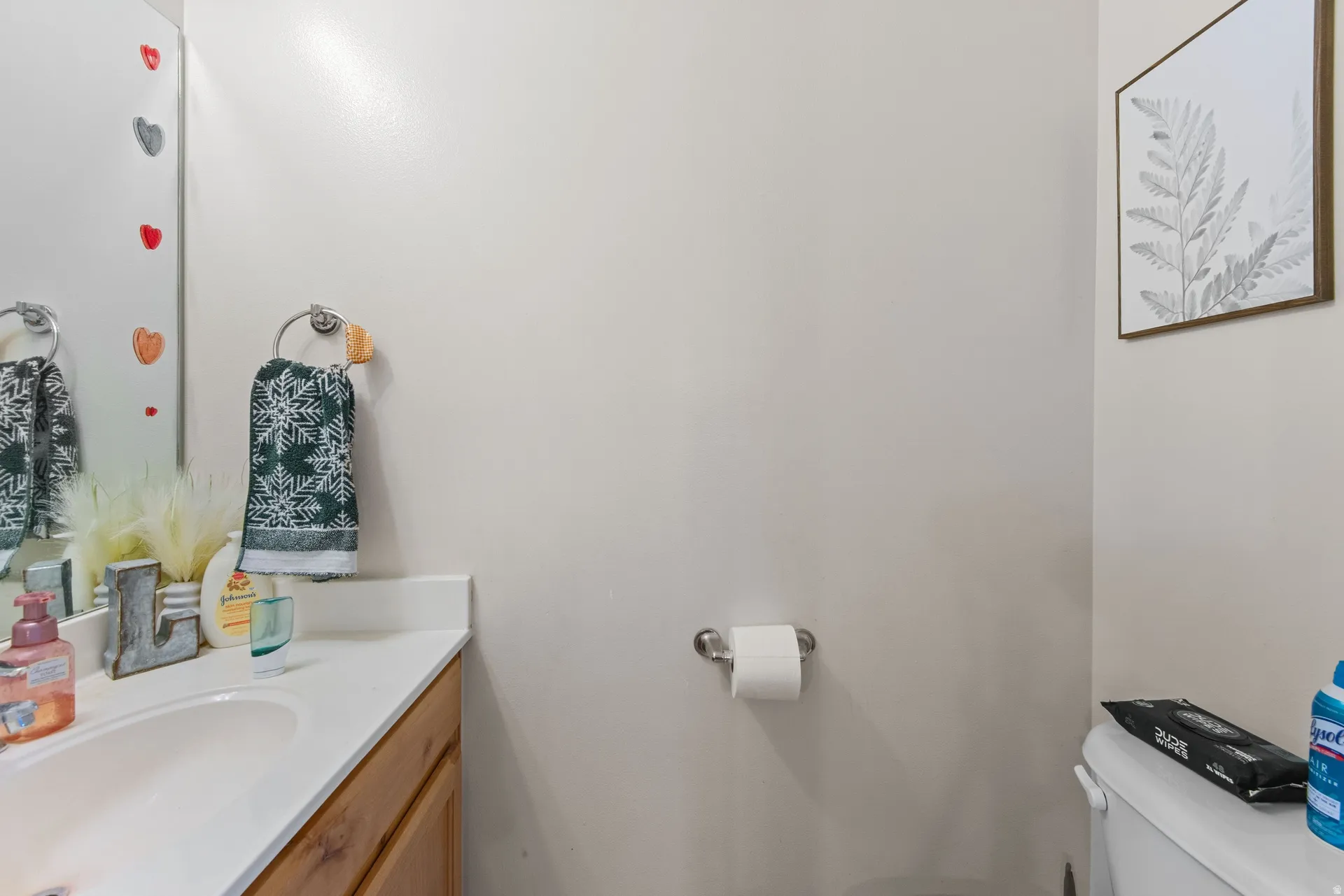 Half bathroom featuring vanity and toilet