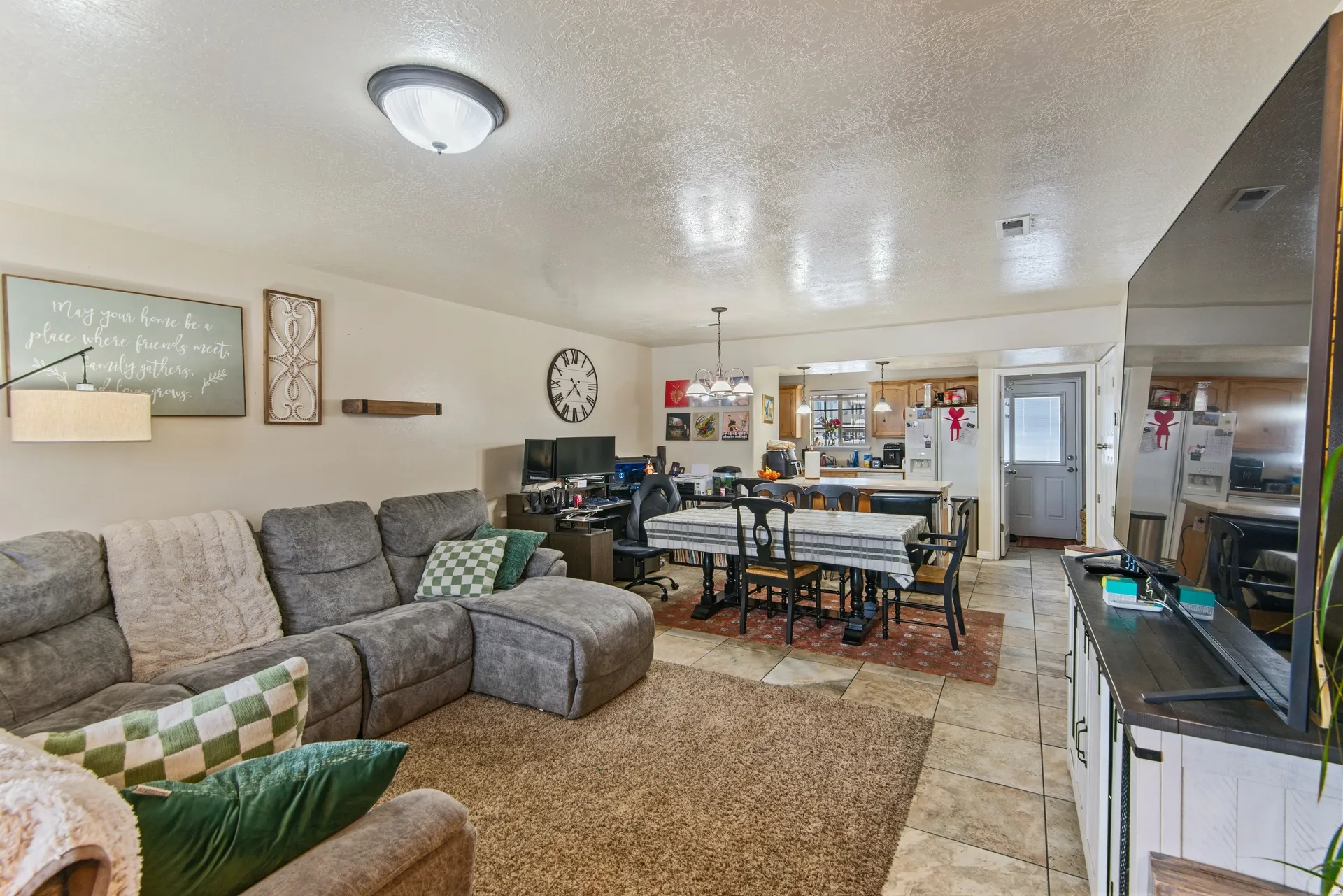 Living area featuring a textured ceiling and a chandelier