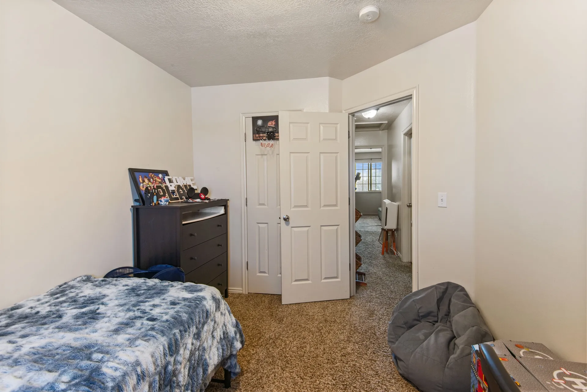 Bedroom with carpet and a textured ceiling