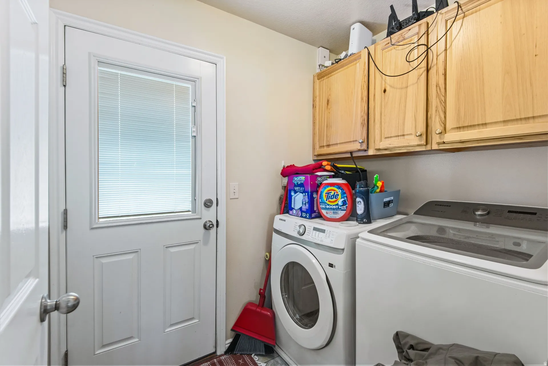 Laundry room featuring separate washer and dryer and cabinet space