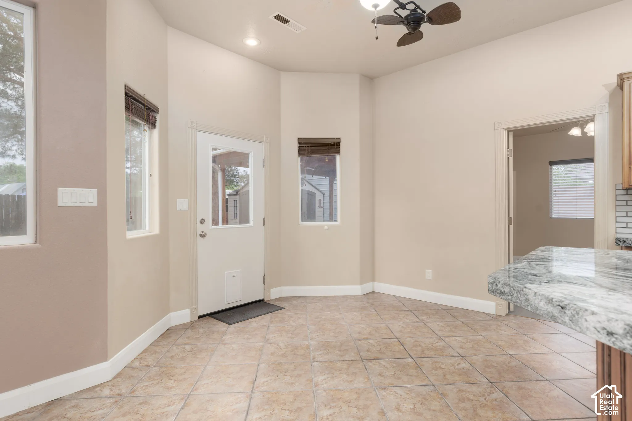Dining area with a ceiling fan, light tile patterned flooring, and recessed lighting